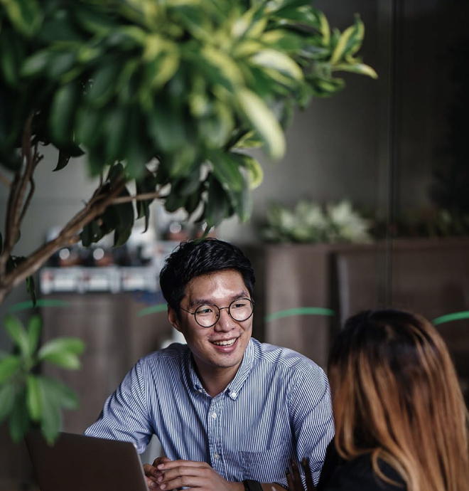 a man smiling at a girl talking to him